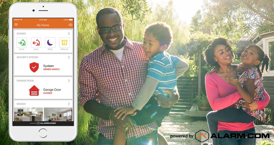 man and woman holding kids with a screenshot of an Alarm.com app interface in the foreground.